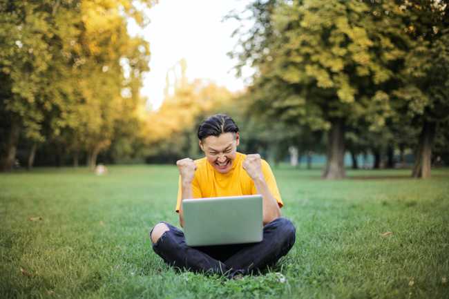 Happy Man Sitting with His Laptop