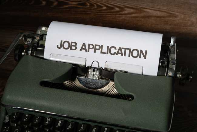 A typewriter with the phrase "Job Application" on the paper