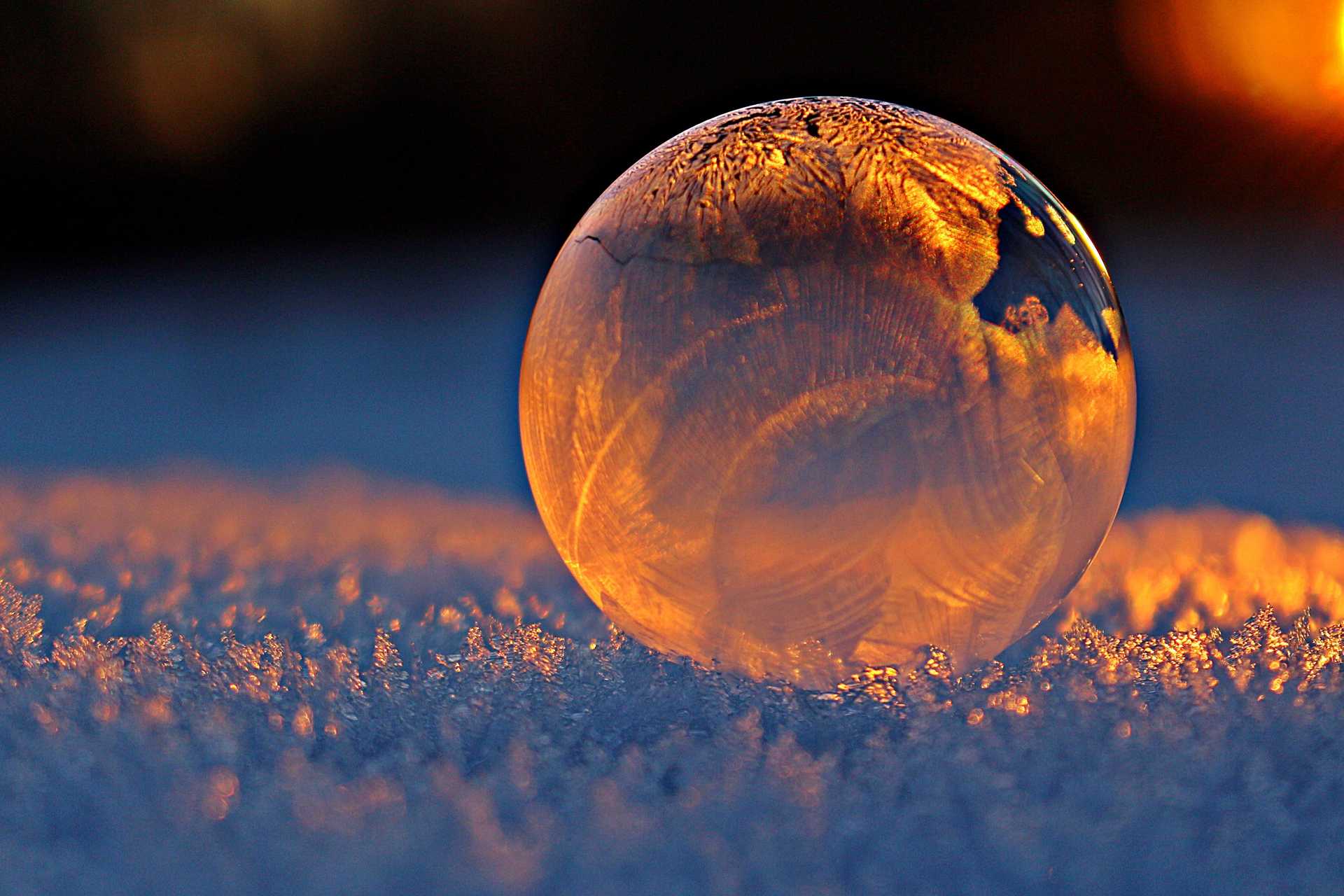 Clear glass sphere on snow