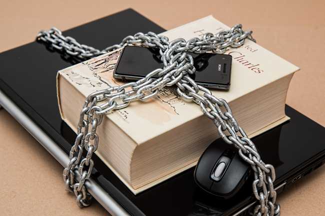 Laptop, Book, and Phone in Chains